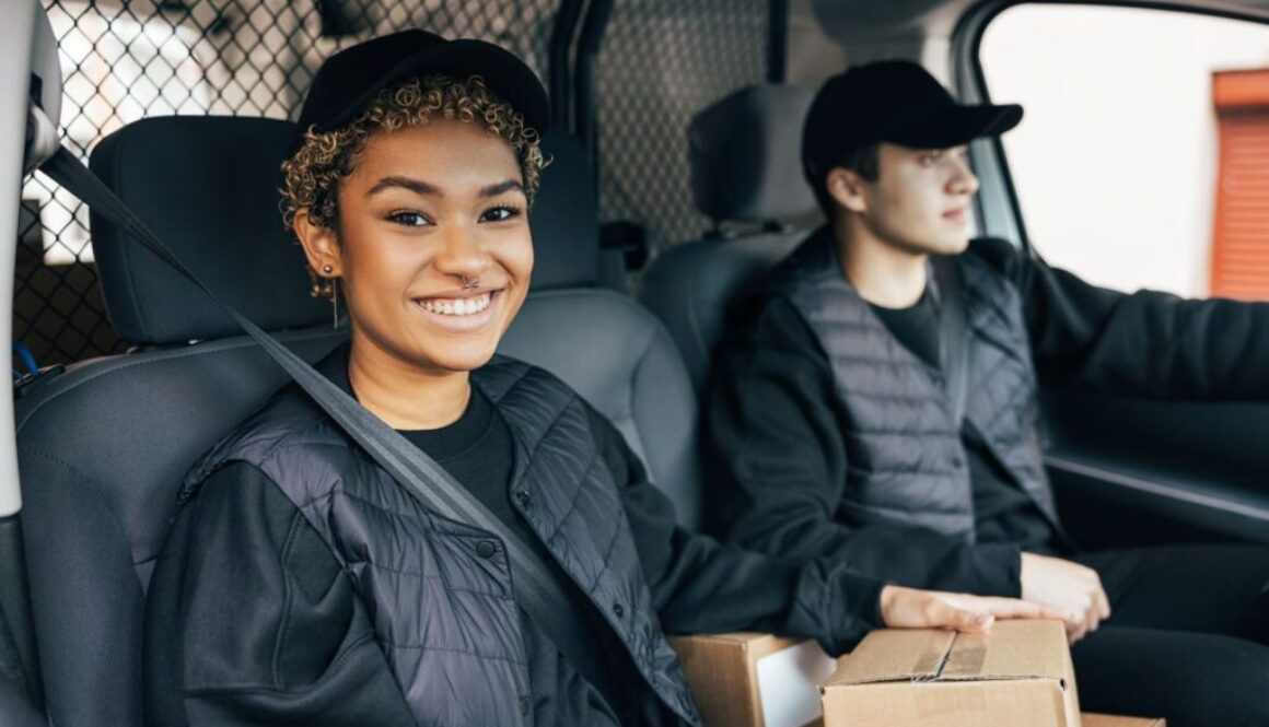 cannabis delivery woman riding in cannabis delivery van smiling