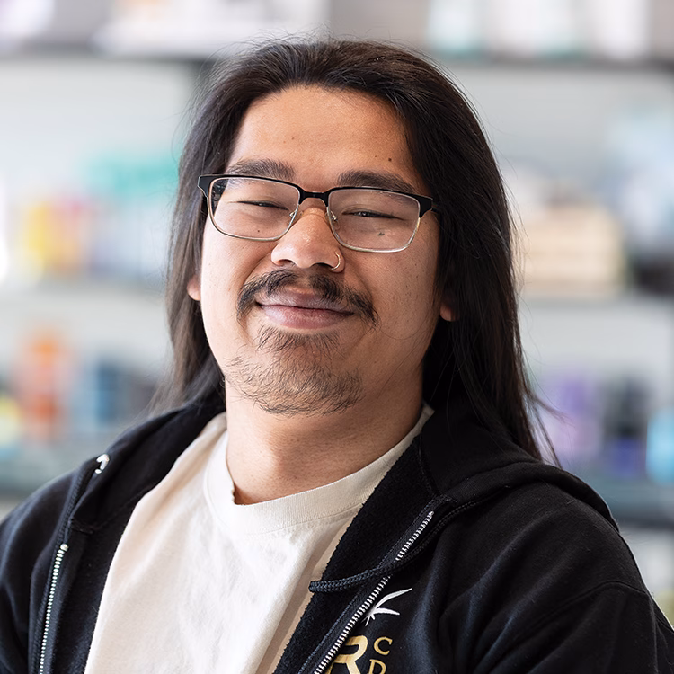 Sam, known as the Weed Whisperer, smiling on the sales floor