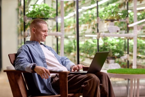 Man relaxing in a chair browsing cannabis products online on laptop